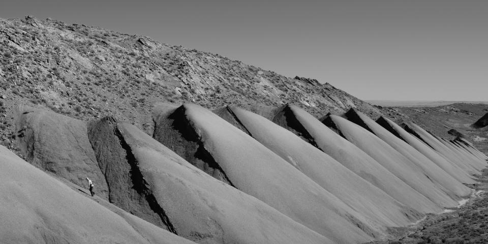 Black and white photo of hills made up of bentonite, but one that has gone through the desqueezing process.
