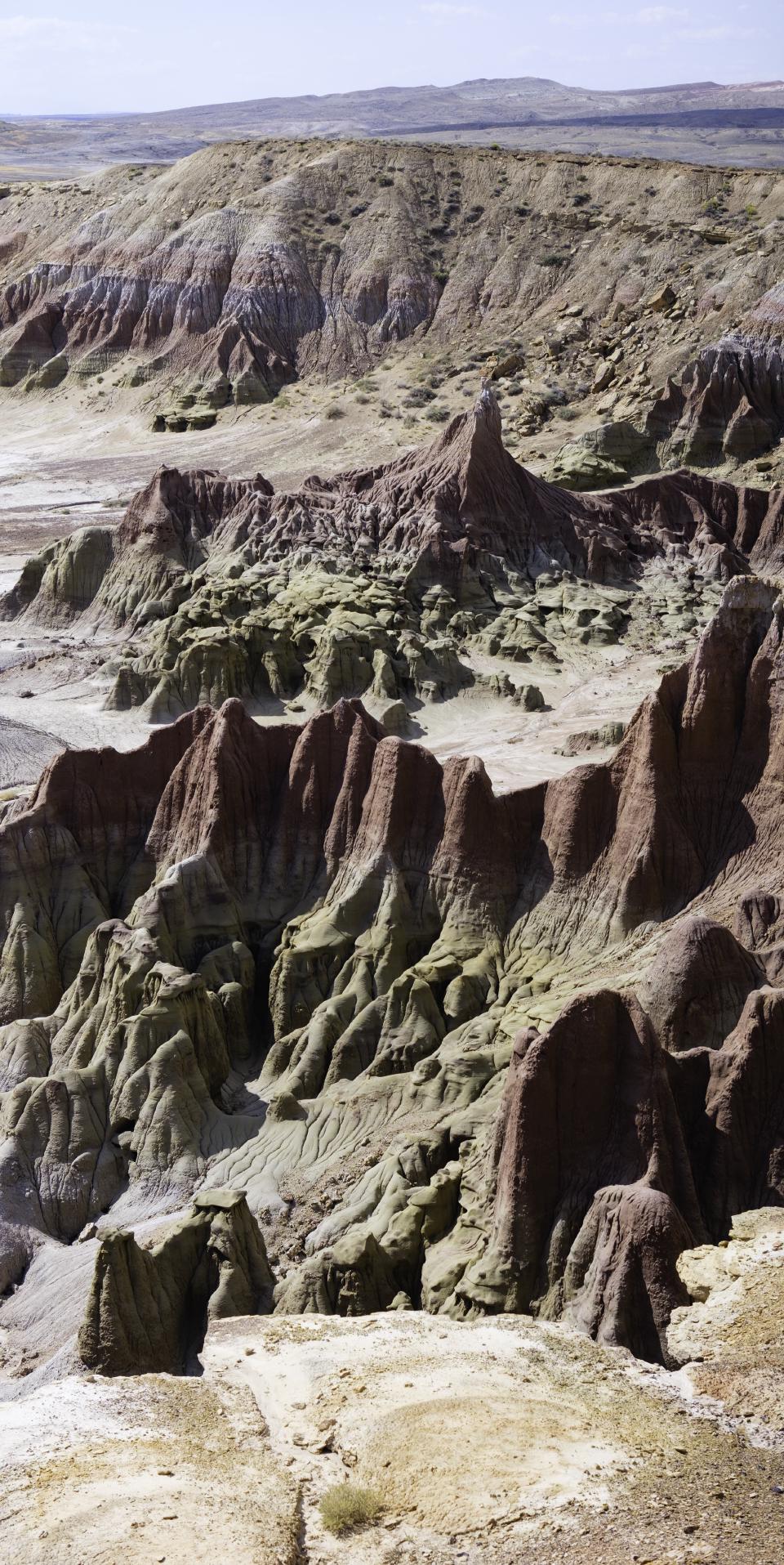 An alien landscape made up of beige to pink rocks that are slowly weathering away.