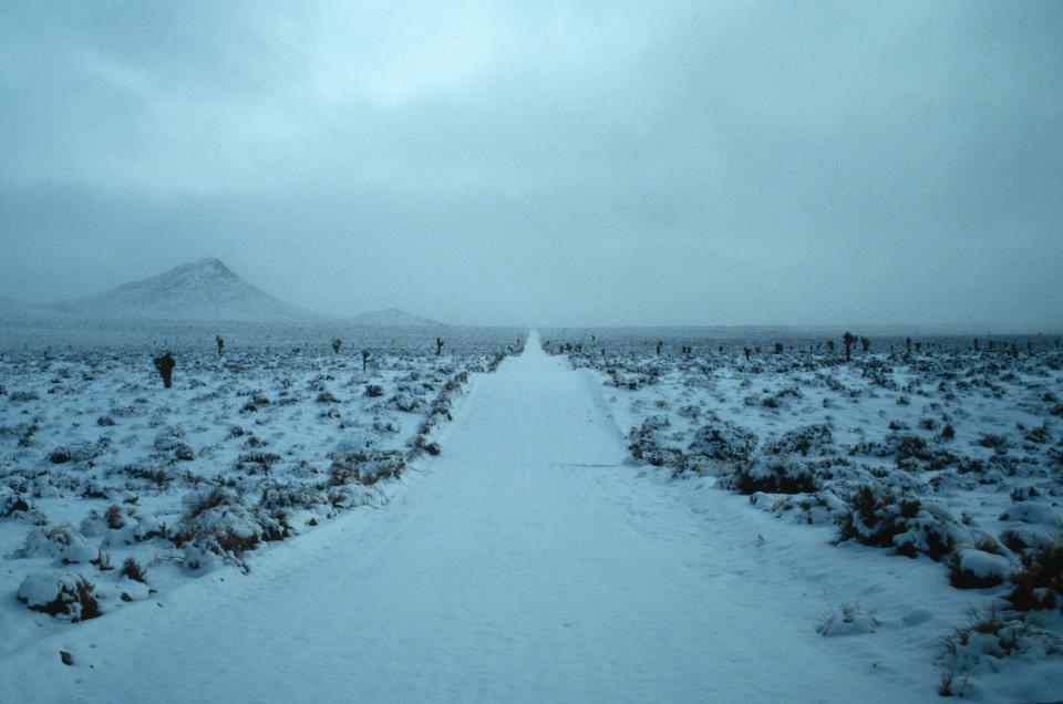 Image of a snow covered road in the desert.